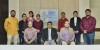 SPA colleagues sit and stand together for a photo with a poster titled 'Water Sensitive Planning Theory for the Global South' visible behind thumbnail